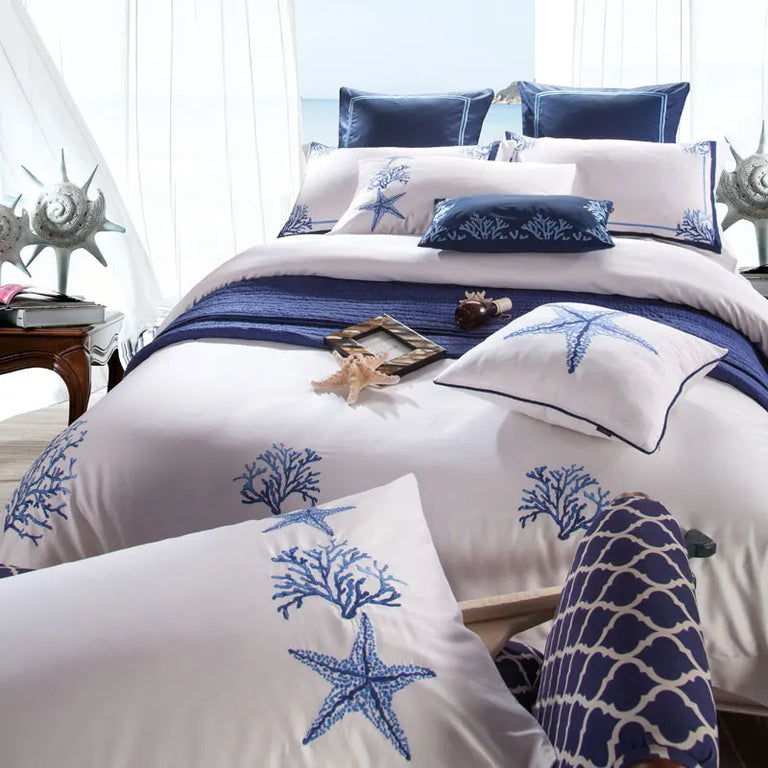 Close view of the blue coral embroidery on the duvet cover and pillowcase