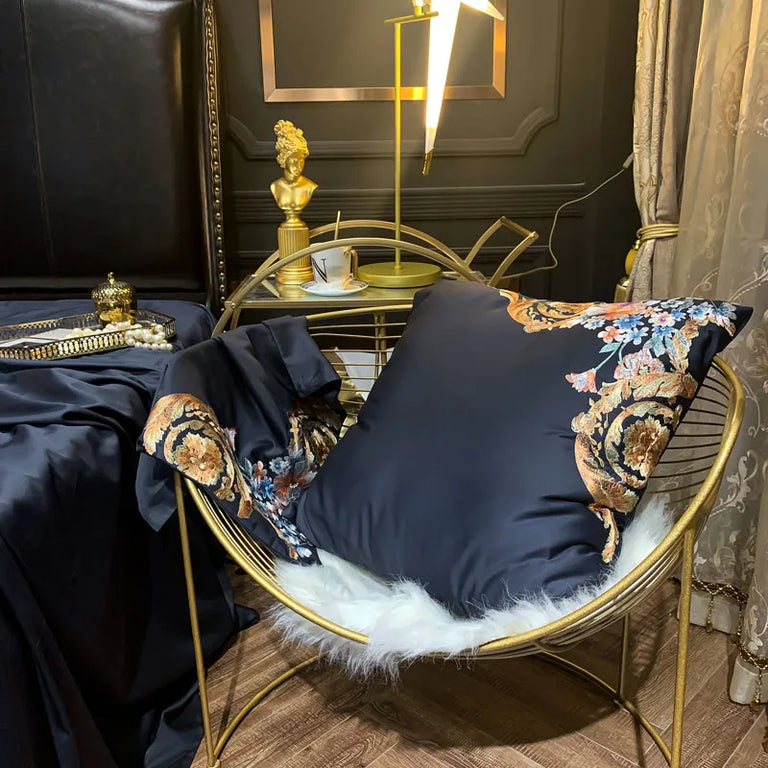 Embroidered navy cushion cover on a gold chair