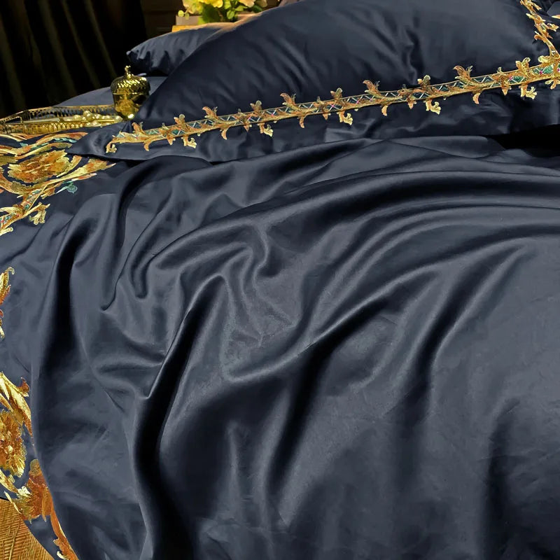 Close up of navy cotton fabric with gold embroidered trim