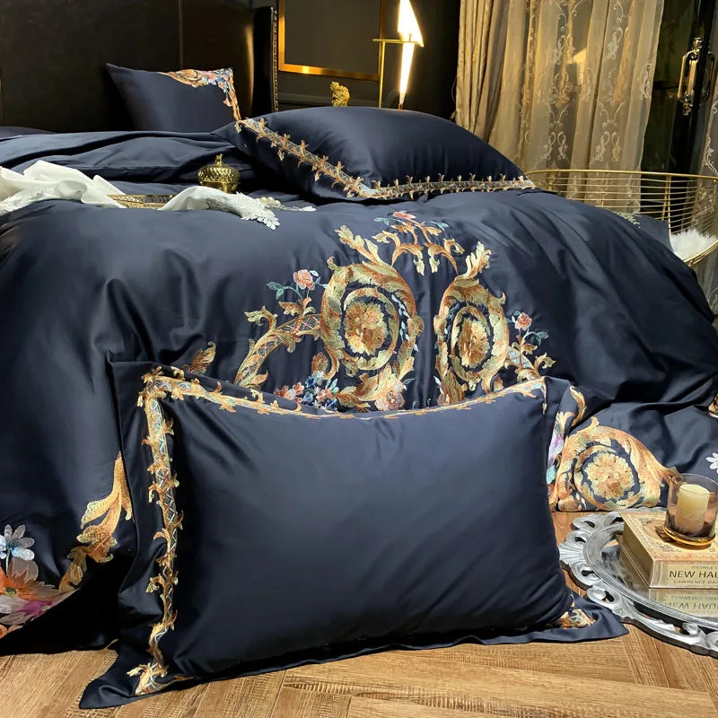 Navy pillowcase with gold embroidered edge on a bed