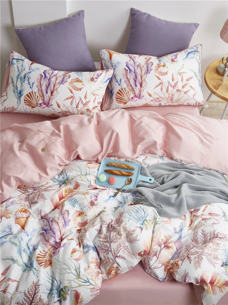 Seashell and coral print pillowcases with a blush pink sheet