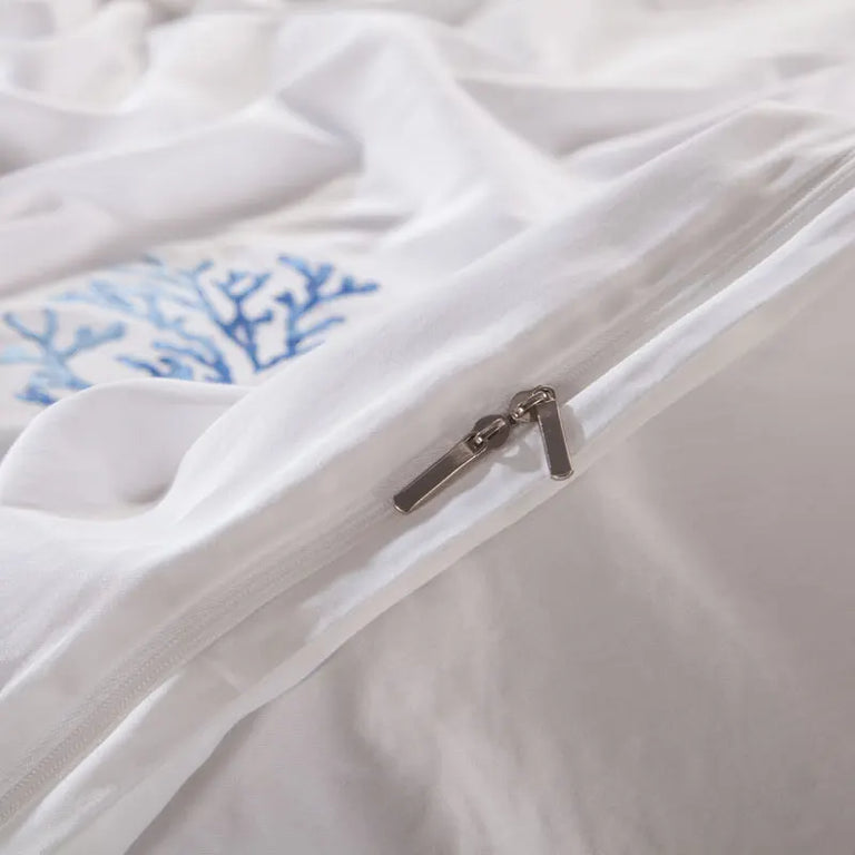Close up of the zip and coral embroidery on white cotton