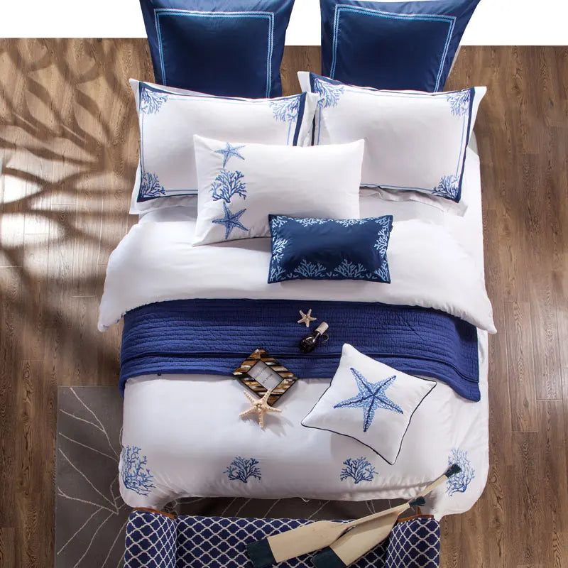 Top view of the white bedding set with blue coral embroidery