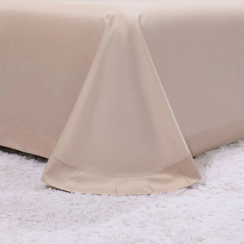 Cream sheet with a wide hem on a fluffy rug