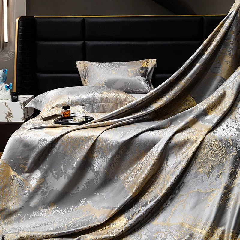 Silver gold jacquard sheet draped over a pillowcase