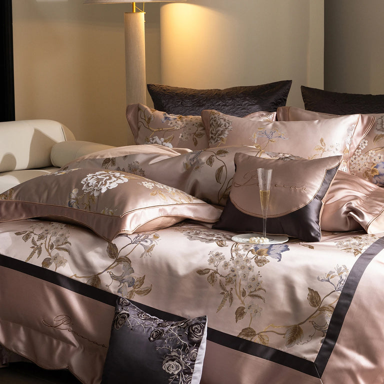 Blush Blossom pillowcases and duvet cover on a bed