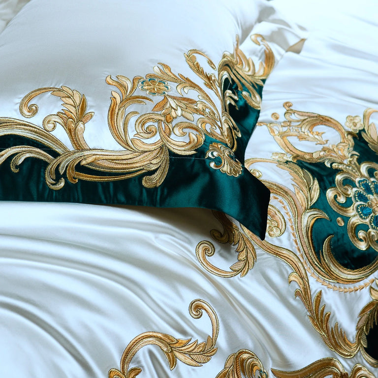 Detail of the gold embroidery and teal border on a pillowcase