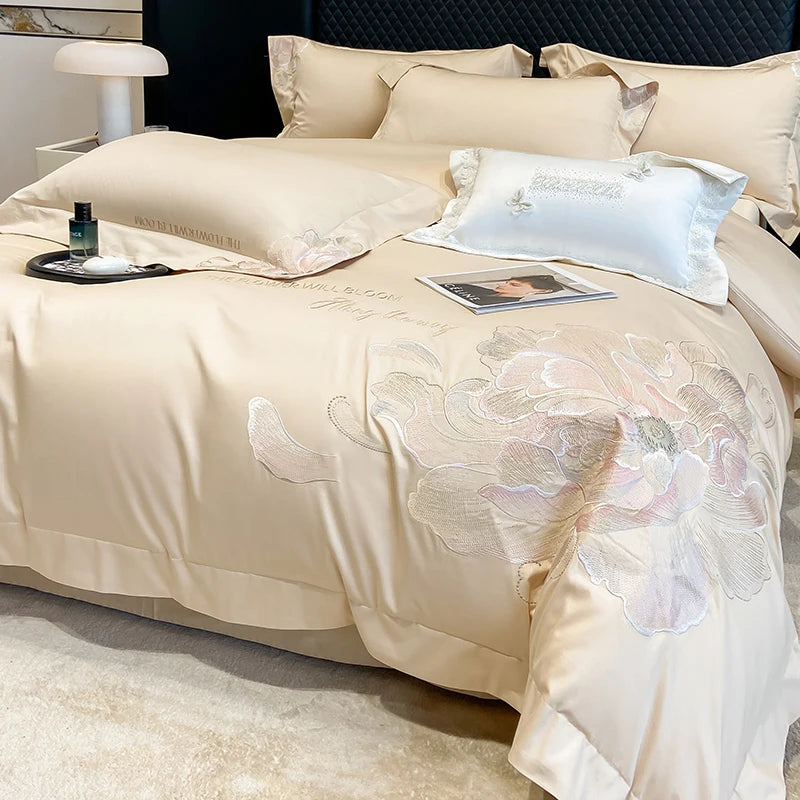 Beige duvet cover with a pale embroidered peony on a bed