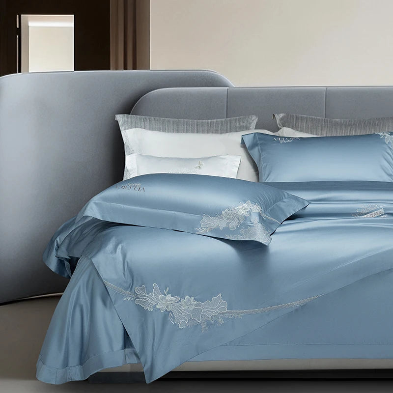 Blue bedding set with embroidered flowers along the hem