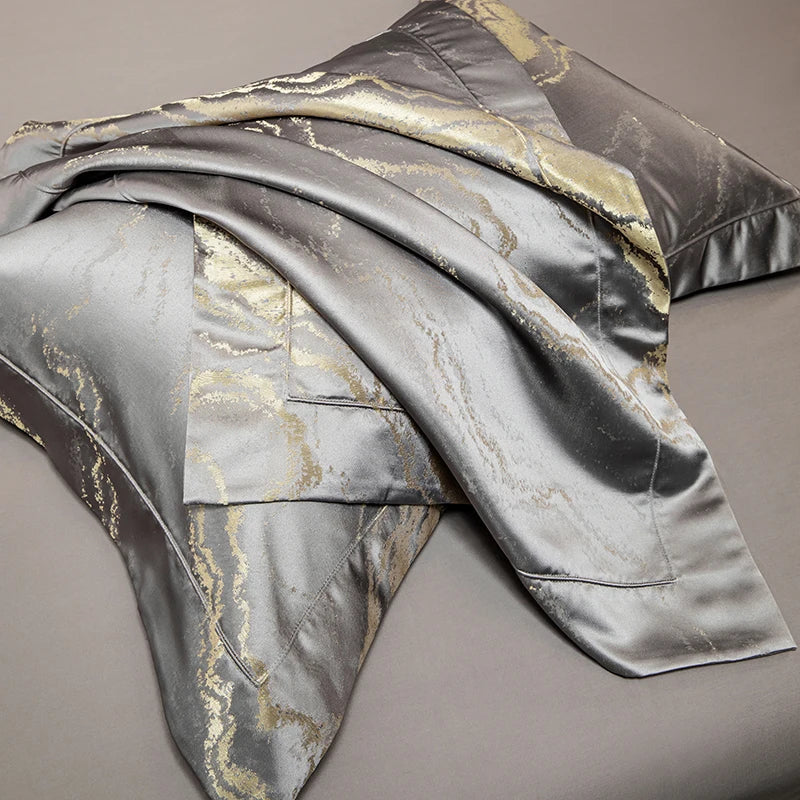 Close up of the gold marble pattern on grey satin