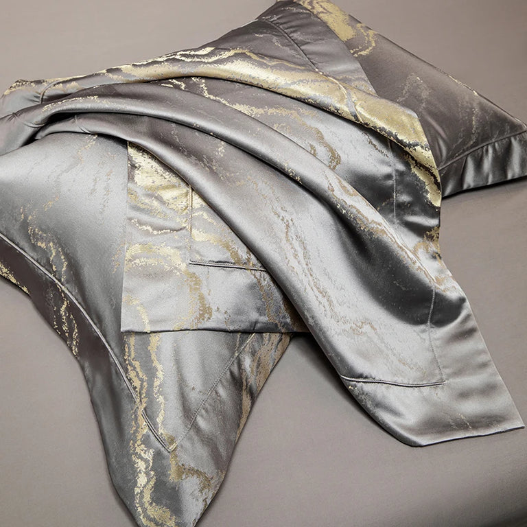 Close up of the gold marble pattern on grey satin
