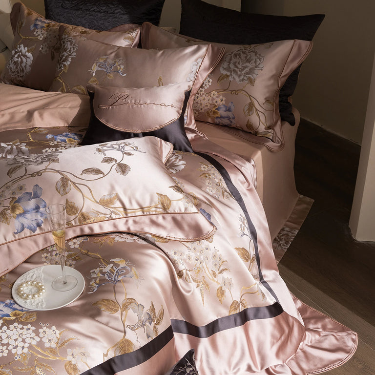 Embroidered flowers and branches on blush pink satin