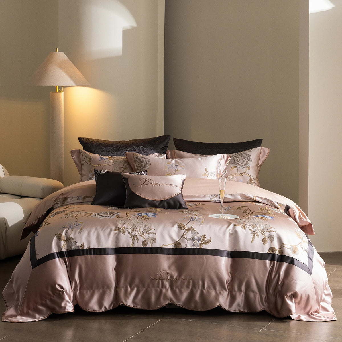 Blush pink satin bedding set with embroidered flowers and a charcoal band