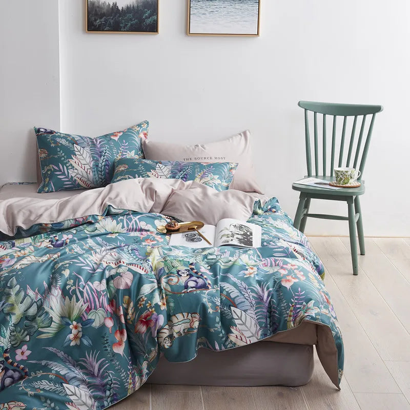 Teal tropical leaf and flower printed Egyptian cotton bedding set on a bed