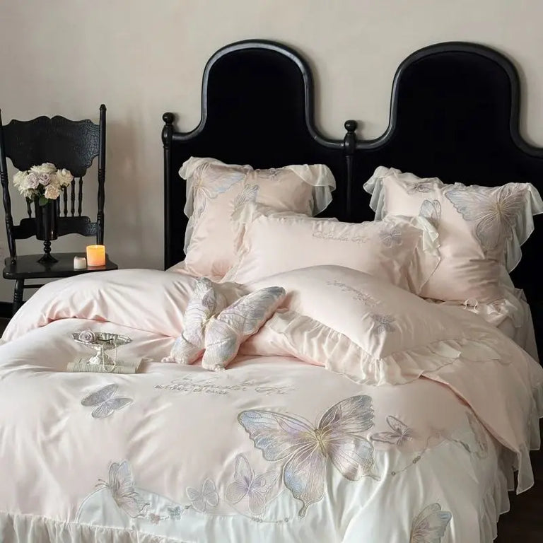 Embroidered butterflies and ruffle trim on the bed