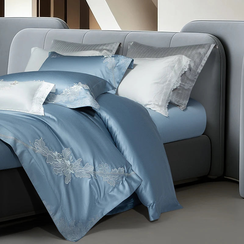 Blue duvet cover with floral embroidery on the corner