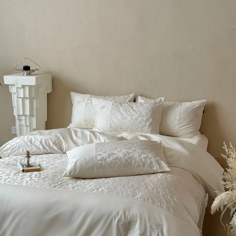 Ivory bedding set with butterfly jacquard pillowcases styled in a bedroom