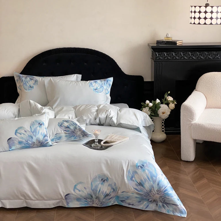 Large blue embroidered flowers on a duvet cover and pillowcases